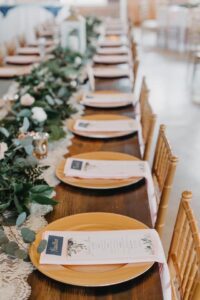 A Bunch of Plates Places on a Long Wooden Table